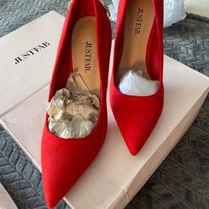 Red heels with gold details on the back.
